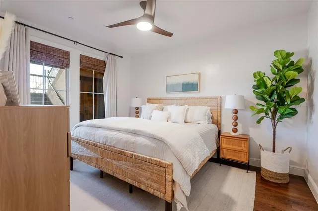 a bedroom with a bed and a potted plant