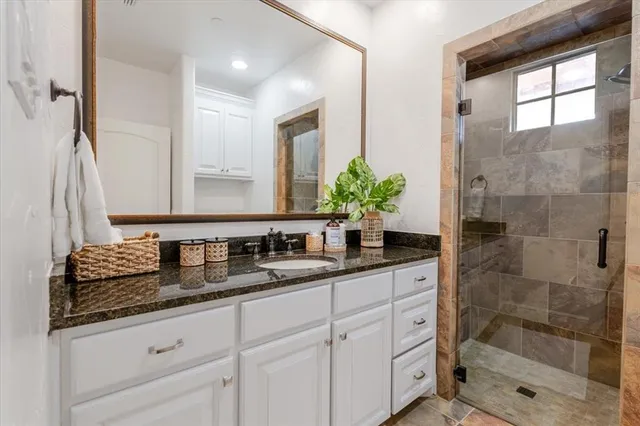 a bathroom with double sink and a mirror