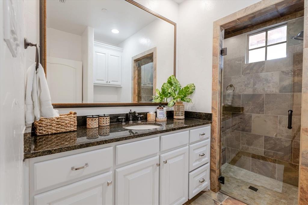1653 Scenic Drive, Unit 102 Graford, TX 76449 - Photo 20 of 40 a bathroom with double sink and a mirror