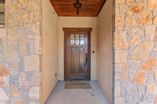 a view of a hallway with wooden cabinets and a stove