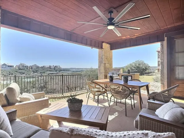 a view of a patio with a table chairs and a umbrella