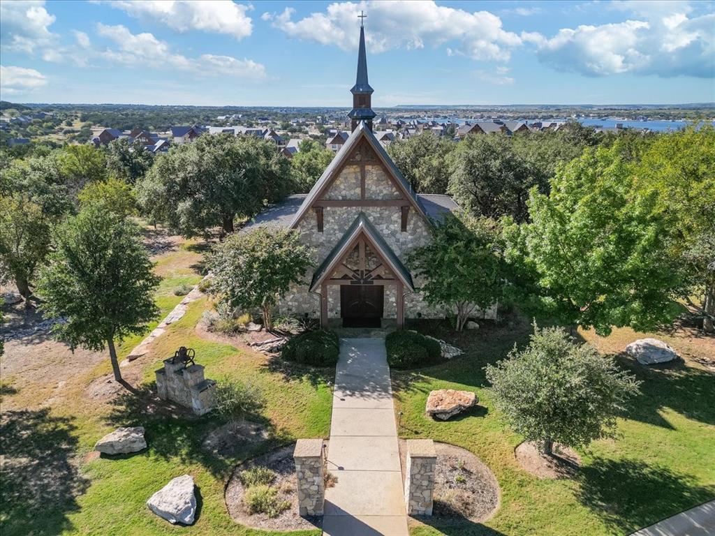 1653 Scenic Drive, Unit 102 Graford, TX 76449 - Photo 33 of 40 a front view of a house with a yard garage and outdoor seating