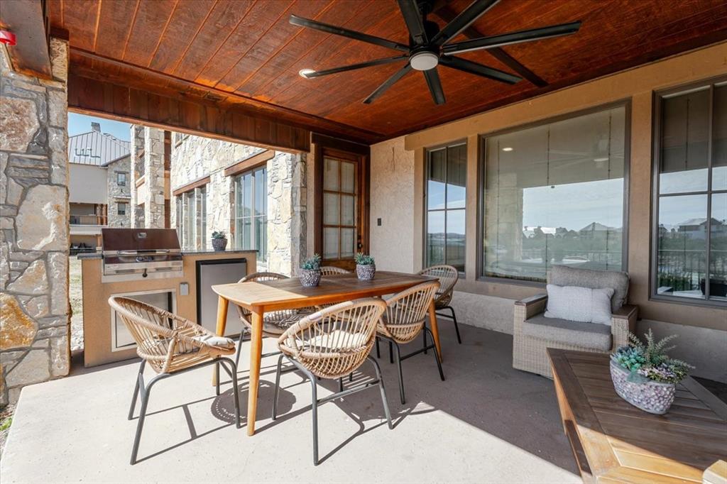 1653 Scenic Drive, Unit 102 Graford, TX 76449 - Photo 5 of 40 a dining room with furniture and large windows