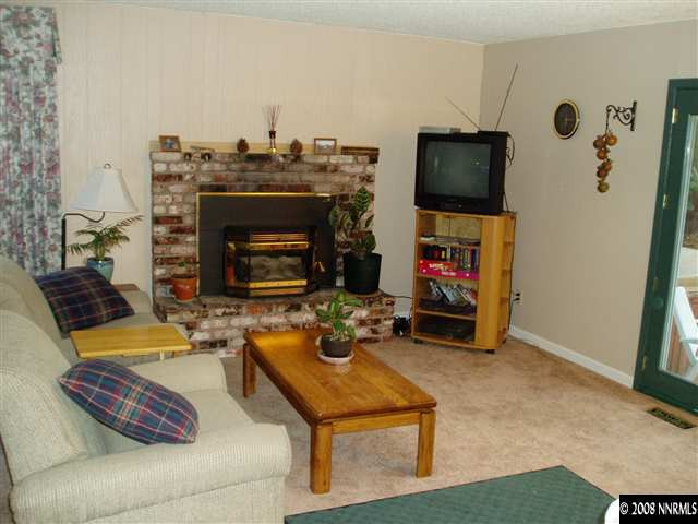 2705 Judith Lane Reno, NV 89503 - Photo 3 of 8 a living room with furniture a flat screen tv and a fireplace