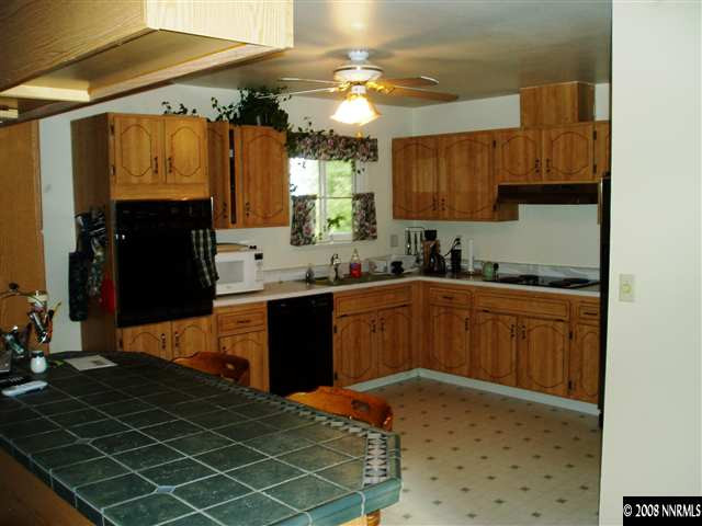 2705 Judith Lane Reno, NV 89503 - Photo 4 of 8 a kitchen with a sink a stove and cabinets