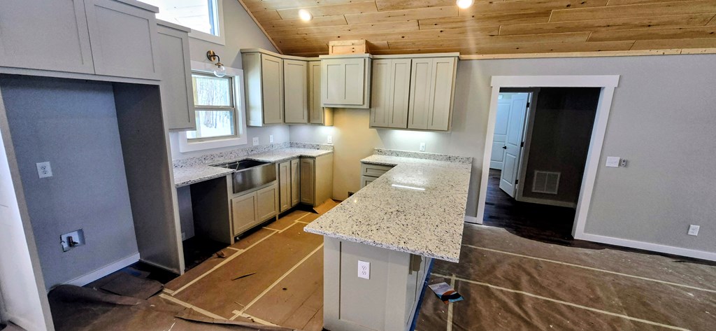 30 Small Street Blairsville, GA 30512 - Photo 24 of 36 a kitchen with granite countertop a sink a stove and refrigerator