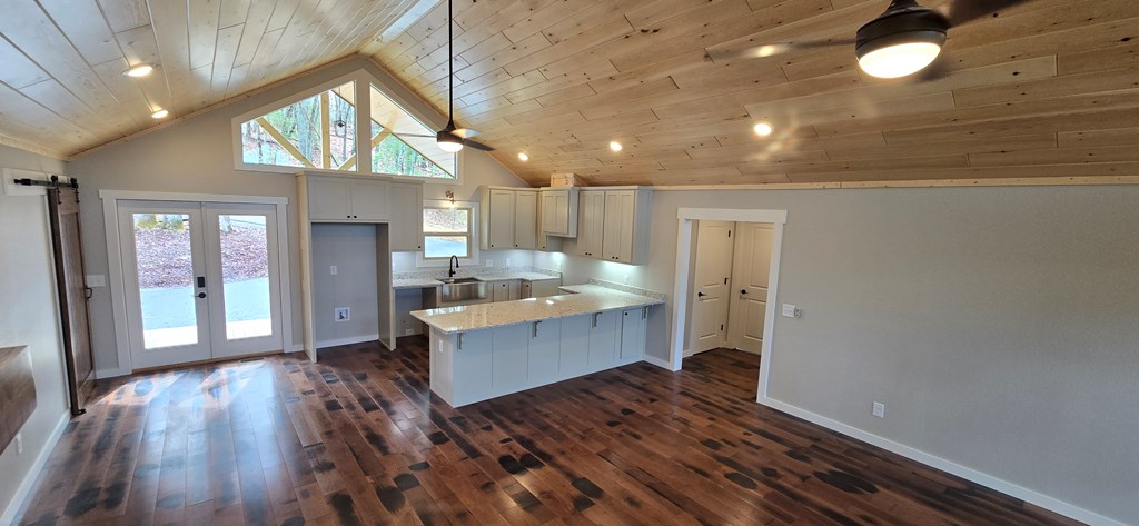 30 Small Street Blairsville, GA 30512 - Photo 27 of 36 a kitchen with kitchen island white cabinets and wooden floor