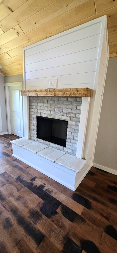 30 Small Street Blairsville, GA 30512 - Photo 28 of 36 a view of an empty room with wooden floor and a fireplace