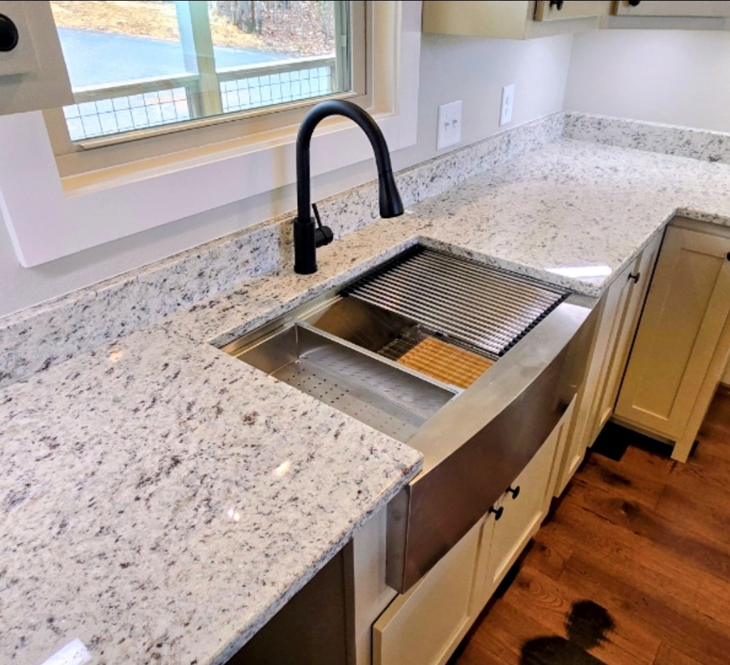 30 Small Street Blairsville, GA 30512 - Photo 31 of 36 a close view of a sink a counter and a stove in a kitchen