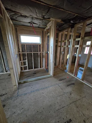 a view of empty room with a fireplace