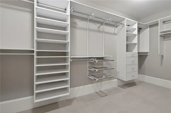 a view of walk in closet with empty racks