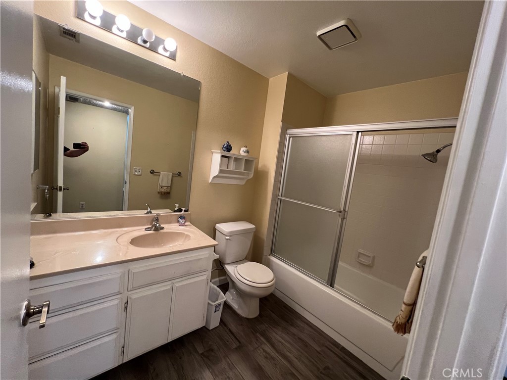 1419 Hancock Circle San Jacinto, CA 92583 - Photo 12 of 23 a bathroom with a sink a toilet a mirror and shower