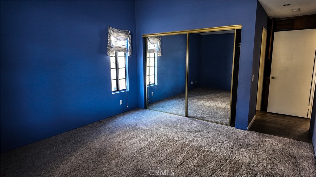 1419 Hancock Circle San Jacinto, CA 92583 - Photo 15 of 23 a view of an empty room with window and wooden floor