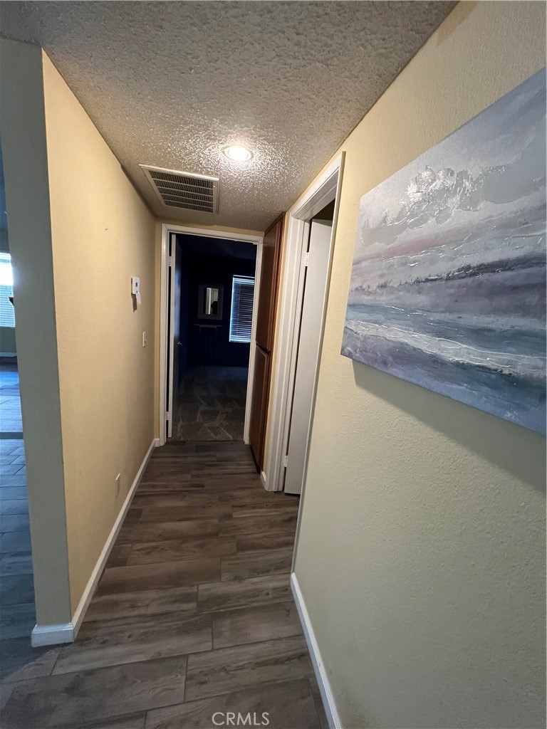 1419 Hancock Circle San Jacinto, CA 92583 - Photo 18 of 23 a view of a hallway with wooden floor and staircase