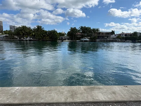 a view of a lake with houses in the back