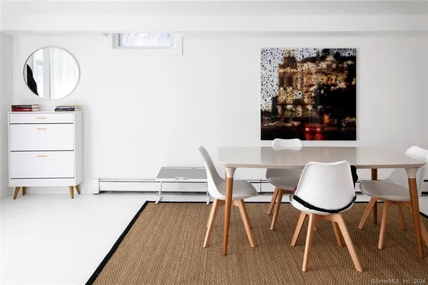 a view of a workspace with furniture and wooden floor