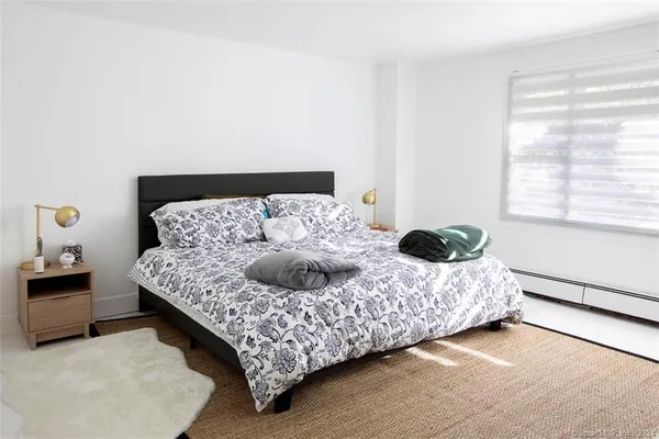 a bedroom with a bed and window