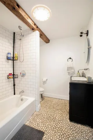 a bathroom with a bathtub and a sink