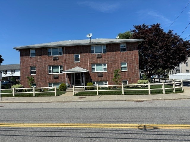 189 River Street, Unit 1 Waltham, MA 02453 - Photo 1 of 5 a view of a house with a balcony