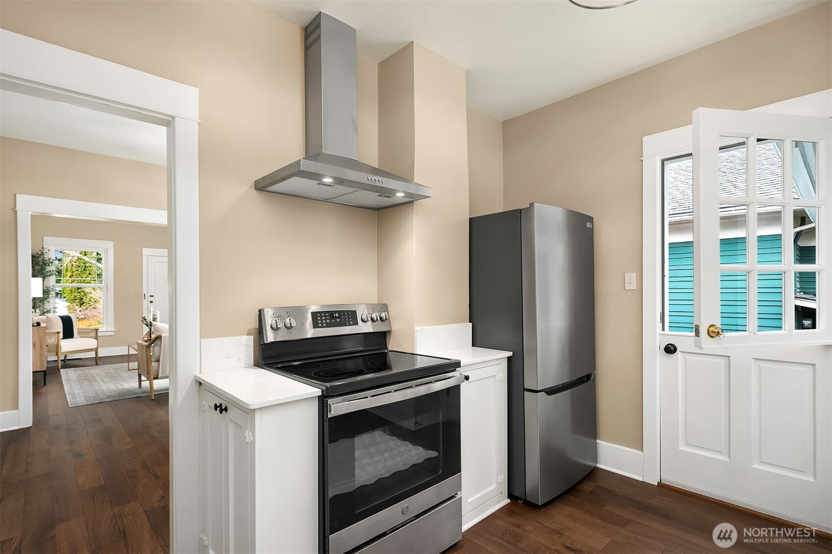 511 West McGraw Street Seattle, WA 98119 - Photo 7 of 21 a kitchen with stainless steel appliances a stove a refrigerator and cabinets