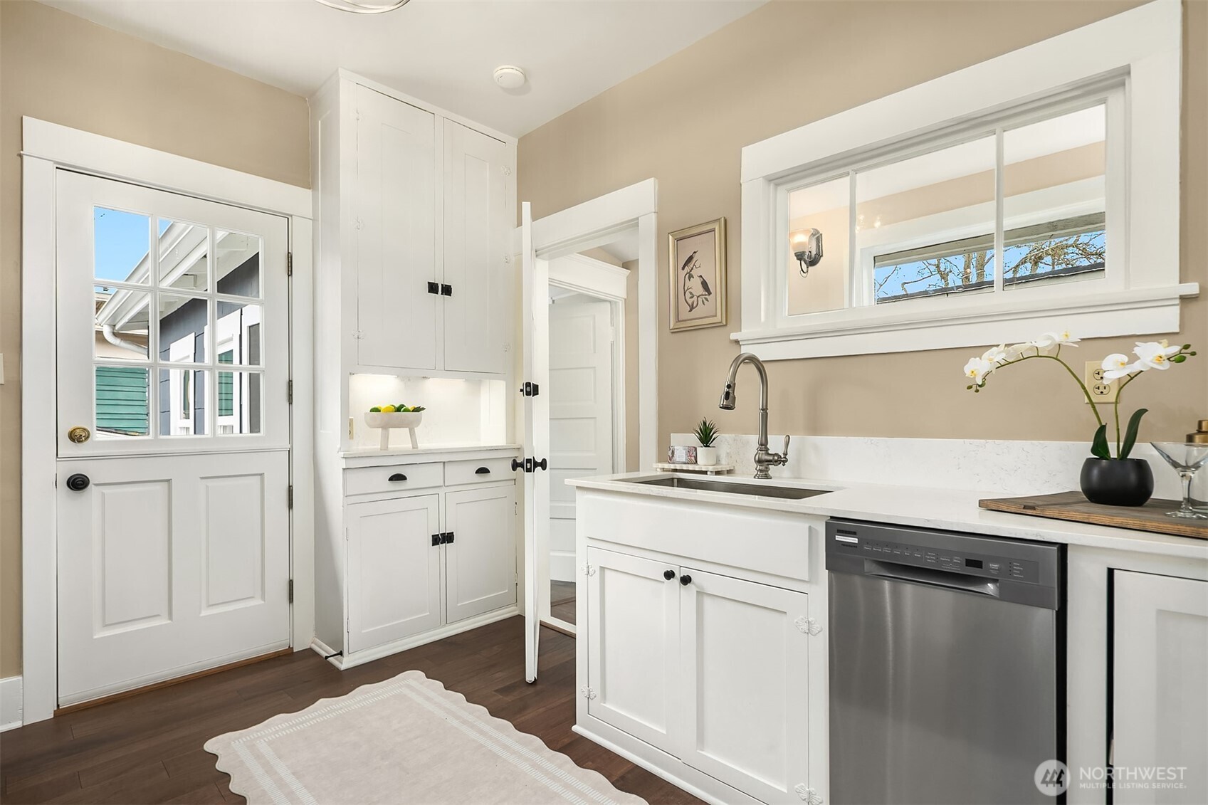511 West McGraw Street Seattle, WA 98119 - Photo 8 of 21 a kitchen with white cabinets and sink