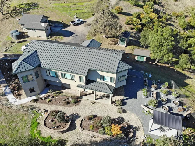 a view of a patio with table and chairs and potted plants