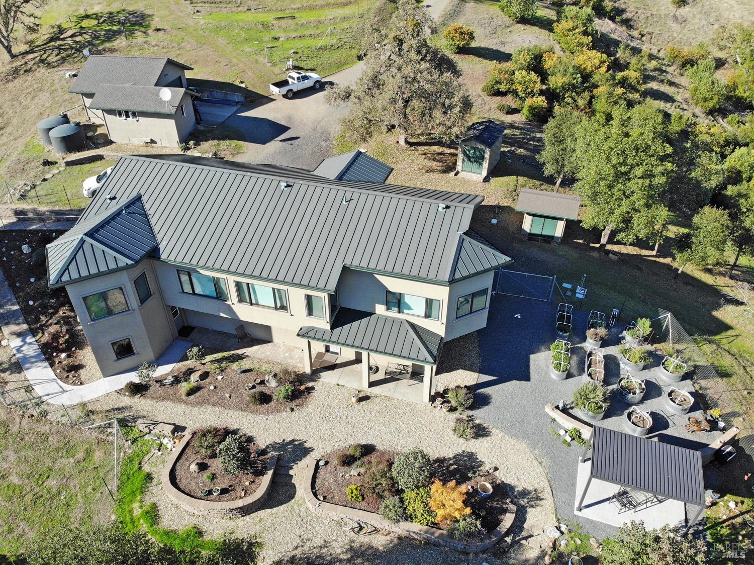 a view of a patio with table and chairs and potted plants