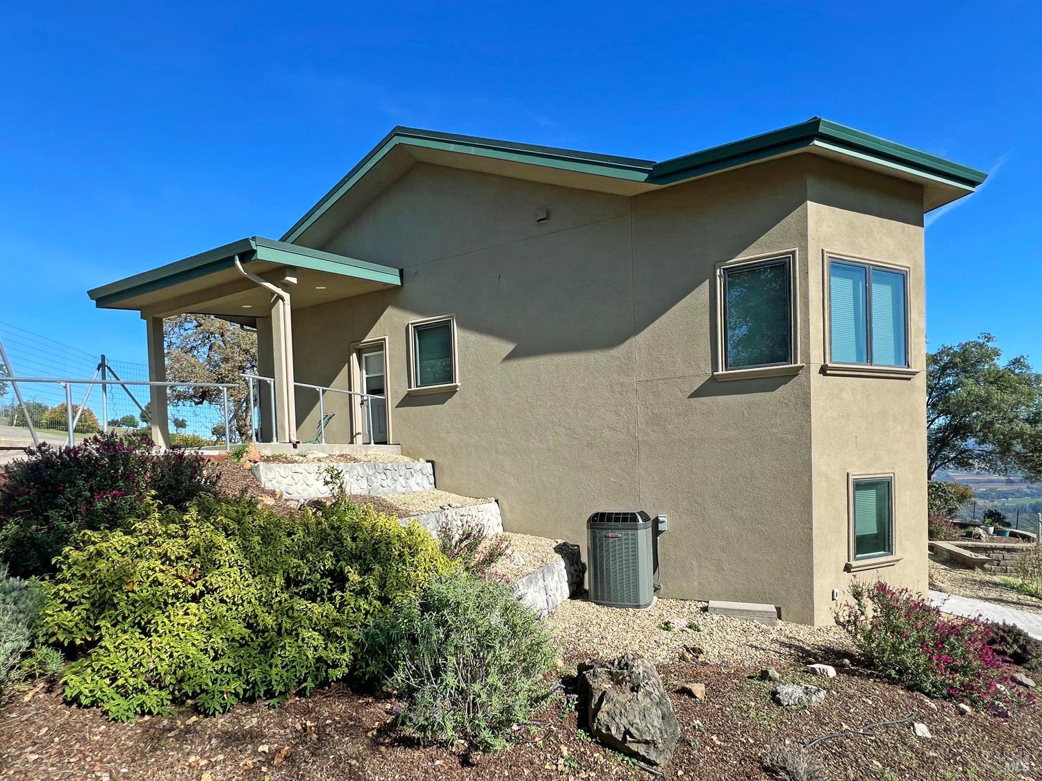 11401 Bakers Creek Road Redwood Valley, CA 95470 - Photo 11 of 70 a front view of a house with garden