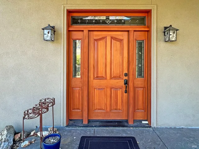 a living room with furniture a dining table and a chandelier