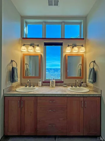 a view of a backyard with table and chairs with wooden fence