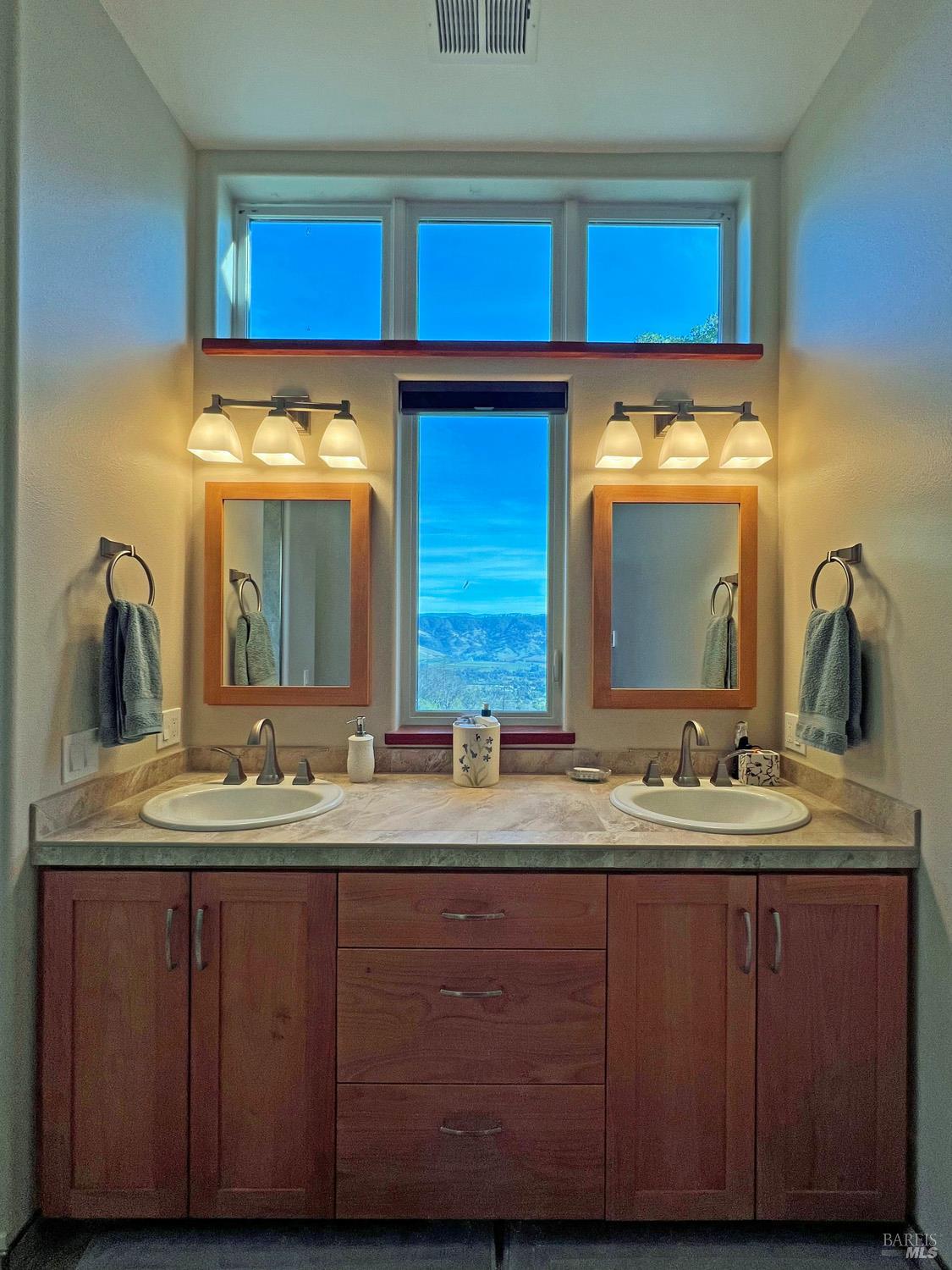 11401 Bakers Creek Road Redwood Valley, CA 95470 - Photo 31 of 70 a bathroom with a double vanity sink and a mirror