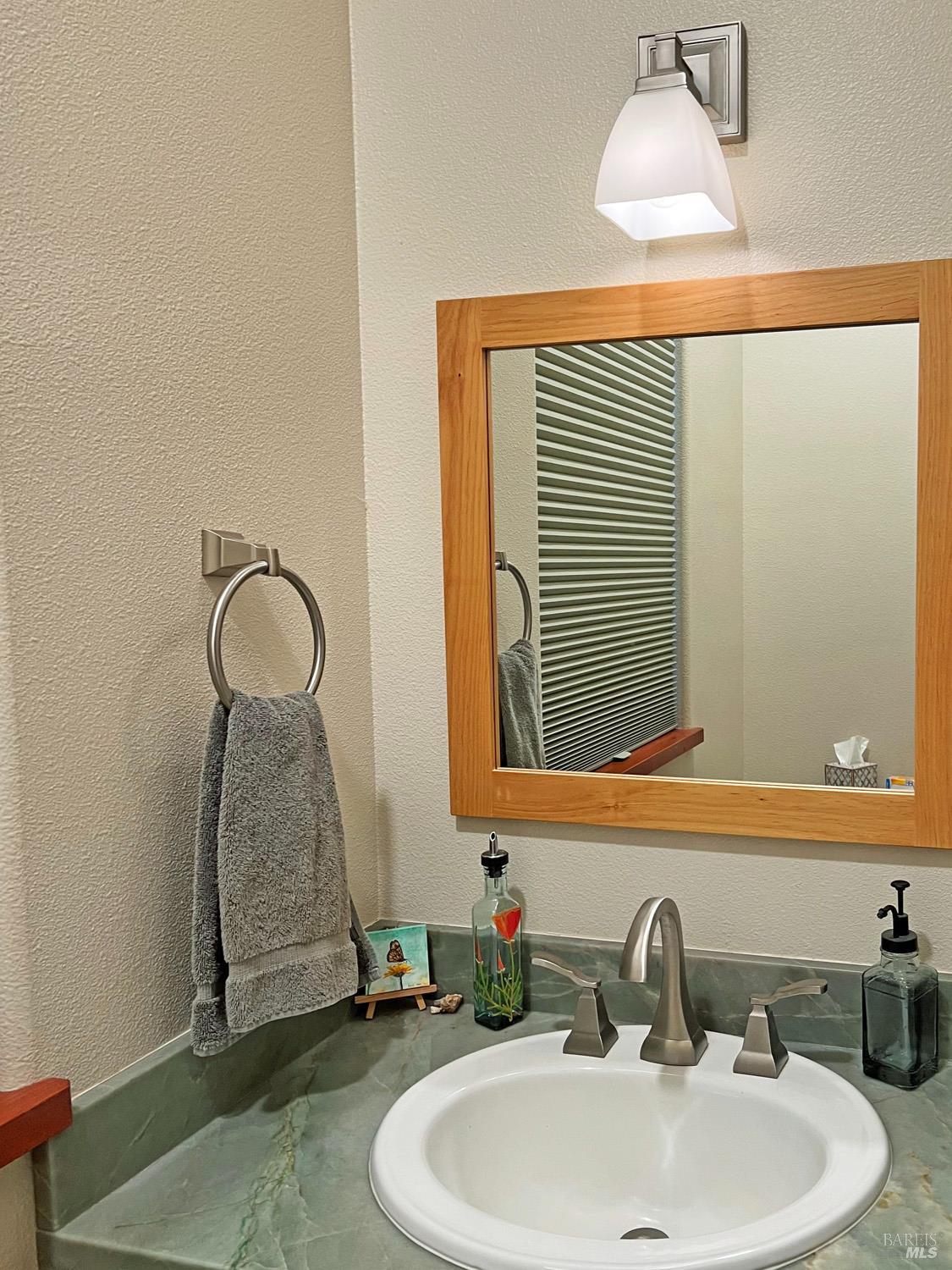 11401 Bakers Creek Road Redwood Valley, CA 95470 - Photo 35 of 70 a bathroom with a sink and a mirror