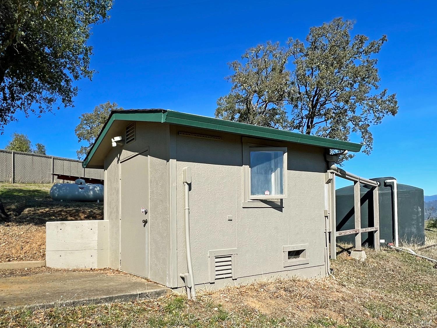 11401 Bakers Creek Road Redwood Valley, CA 95470 - Photo 43 of 70 a side view of a house with a tree