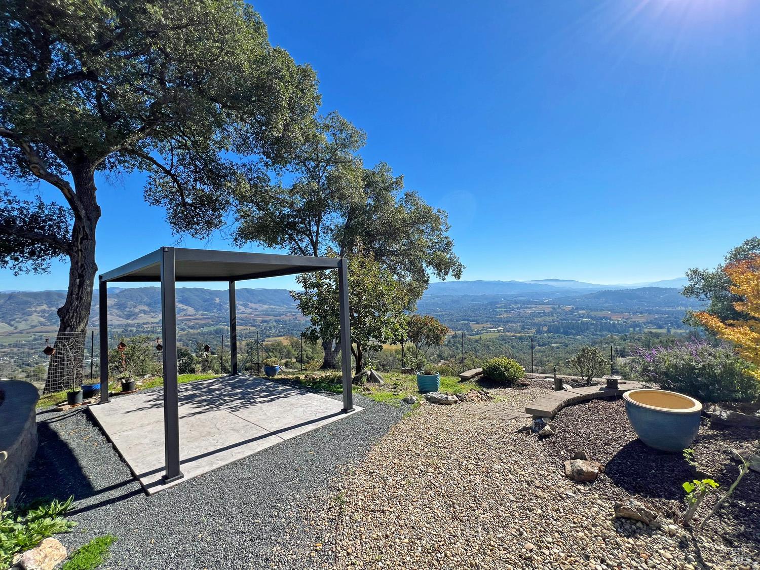 11401 Bakers Creek Road Redwood Valley, CA 95470 - Photo 46 of 70 a view of a terrace with a table and chairs under an umbrella