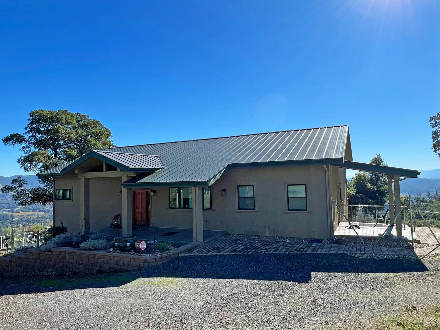 11401 Bakers Creek Road Redwood Valley, CA 95470 - Photo 5 of 70 a front view of a house with garden
