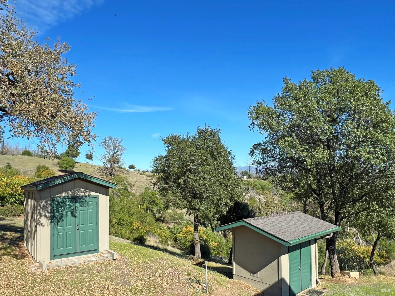 11401 Bakers Creek Road Redwood Valley, CA 95470 - Photo 64 of 70 a view of a patio with table and chairs under an umbrella