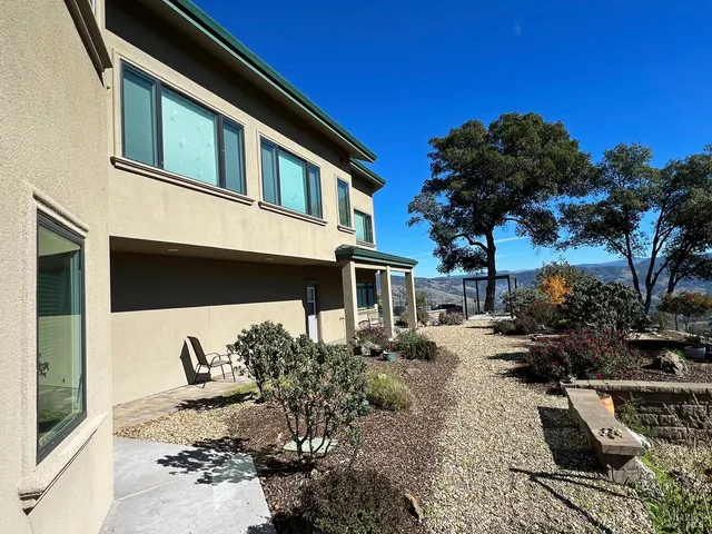 a view of a backyard with sitting area