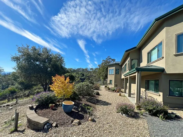 a kitchen with granite countertop a sink a counter top space appliances and cabinets