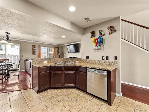 a kitchen with granite countertop a sink and a stove