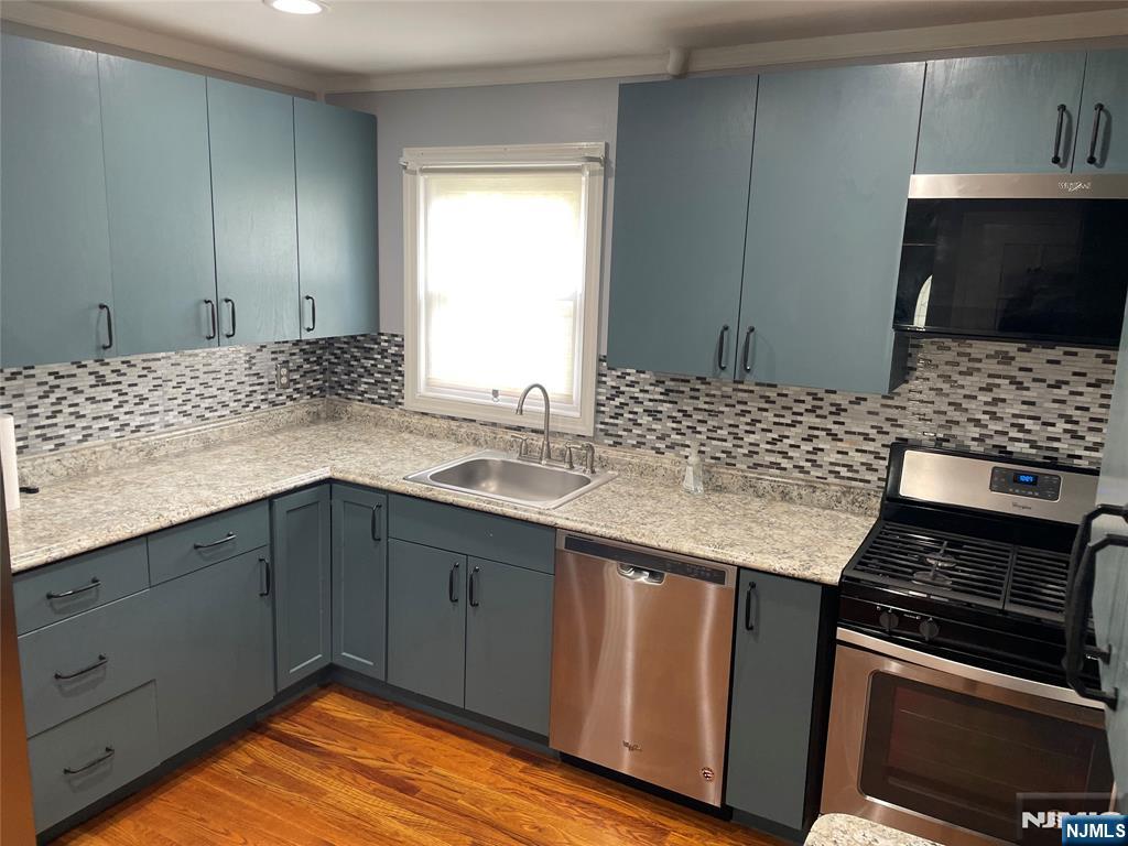12 Fordham Road Oakland, NJ 07436 - Photo 13 of 26 a kitchen with a sink stove and cabinets