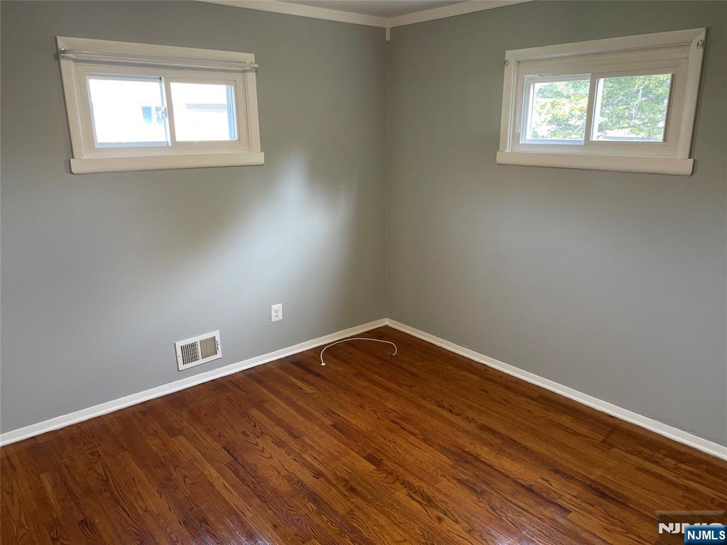 12 Fordham Road Oakland, NJ 07436 - Photo 7 of 26 an empty room with wooden floor and windows
