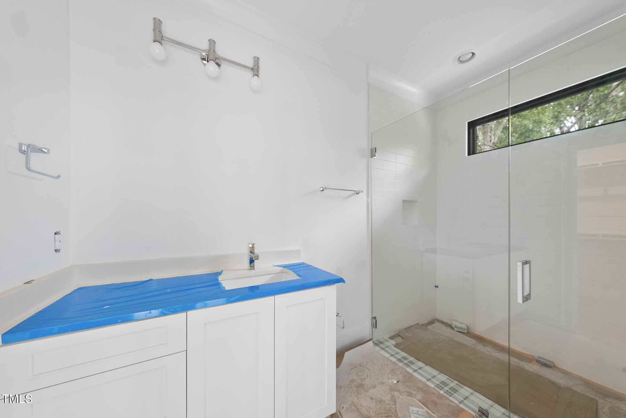 5013 Coronado Drive Raleigh, NC 27609 - Photo 38 of 76 a bathroom with a sink and a shower