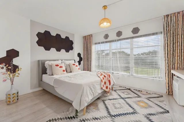 a bedroom with a bed and a window