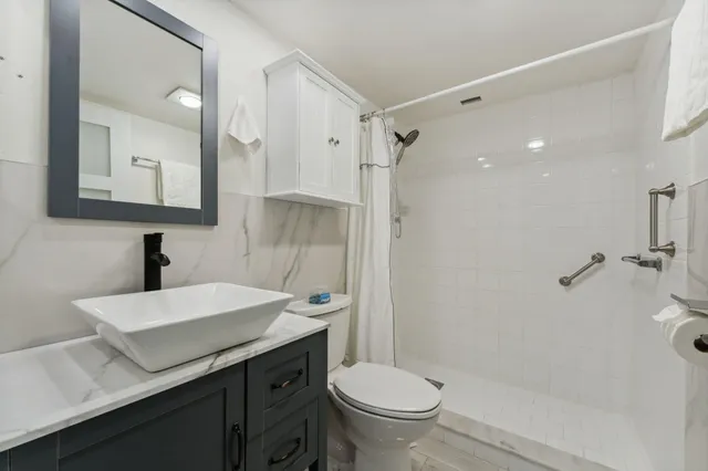a bathroom with a sink toilet and shower