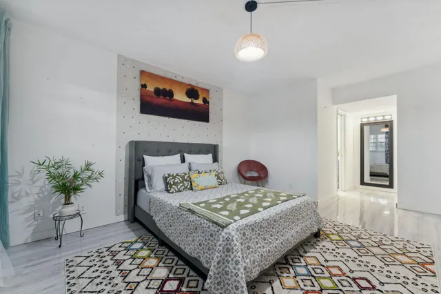 a living room with a couch and a potted plant