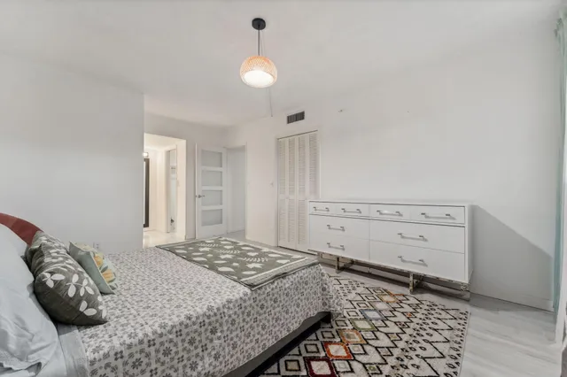 a bedroom with a bed and a cabinets