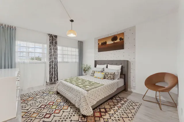 a bedroom with a bed and a table in it