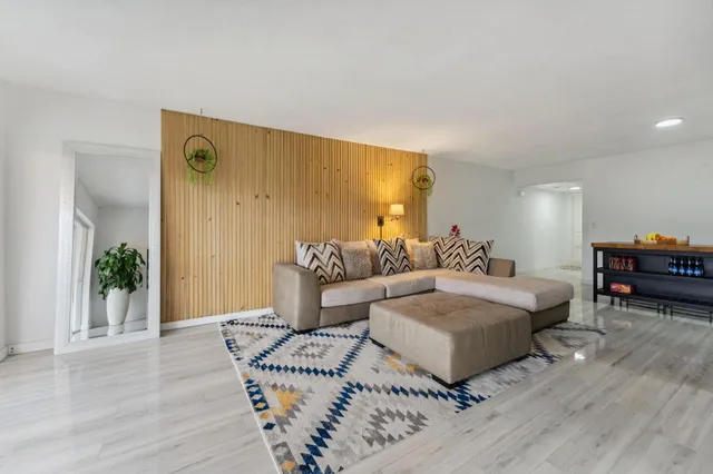 a spacious bedroom with a bed and wooden floor