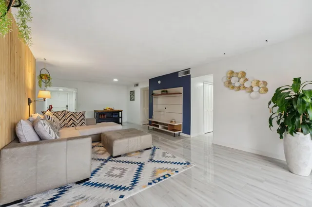 a bedroom with furniture and a potted plant
