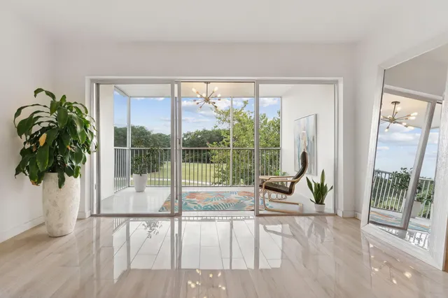 a living room with furniture and a floor to ceiling window